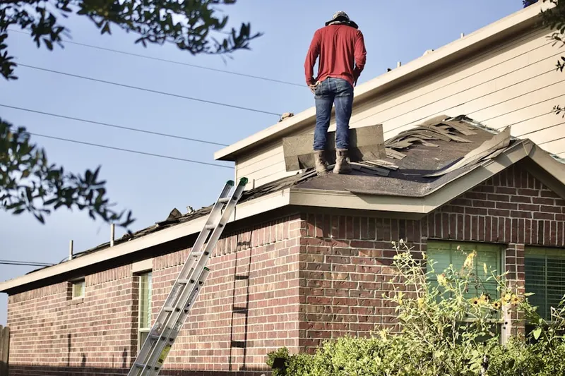 Professional roofer working on a residential roof in Lawrenceville